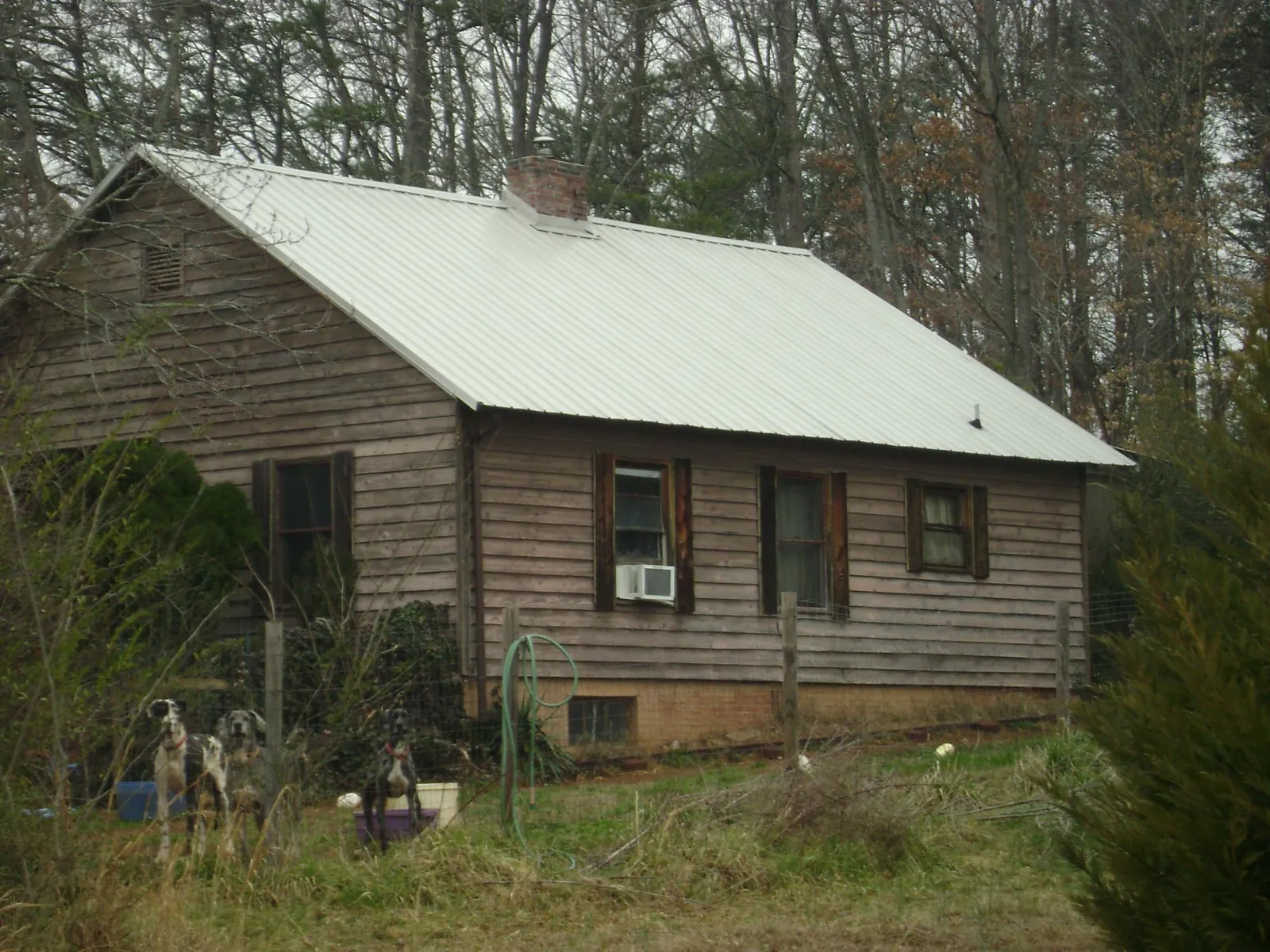 White metal roof on an old wood sided farmhouse, from a Metal Roof Installation job in Hostetter